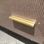 Elegant Curved TV Stand with Textured Panels, Cream Frame and Brushed Gold Hardware